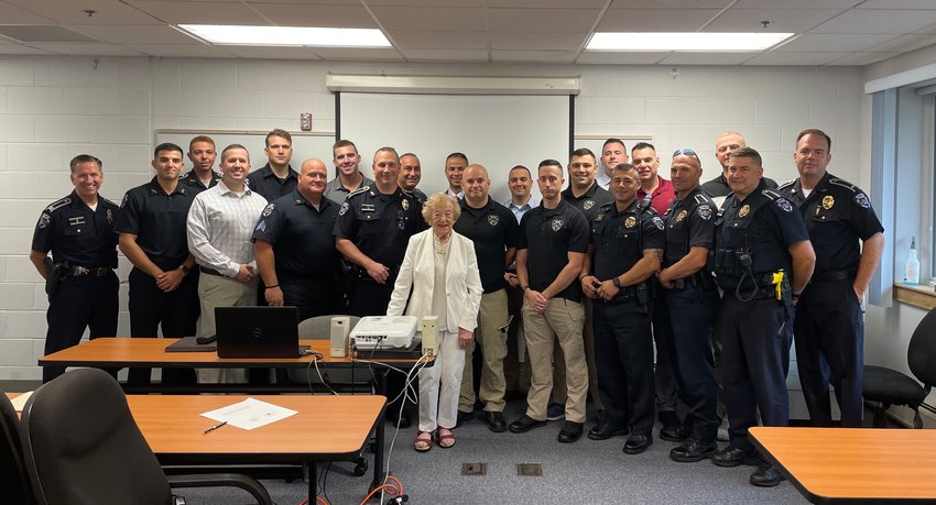 Barrington resident Ruth Oppenheim (center) stands with members of the Barrington Police Department after sharing her first-person account of &ldquo;Kristallnacht&rdquo; (Night of Broken Glass) in 1938 Germany. BPD Chief Michael Correia (left) helped organize the recent event.