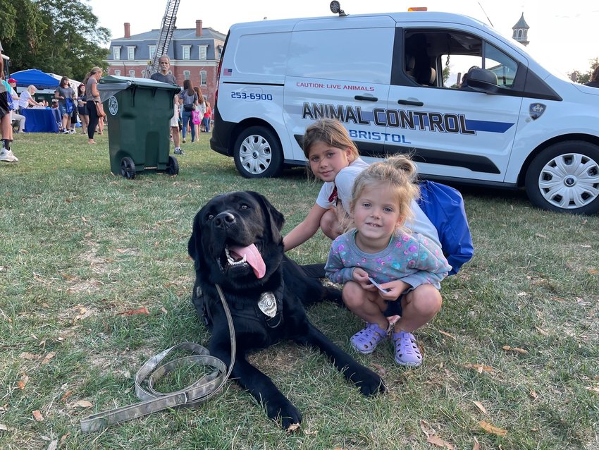 Sofia Clarizio, 7, and her sister Giavanna, 4, enjoy making the acquaintance of K9 Marty, the East Providence Police Department&rsquo;s first Comfort Dog. Marty, who was accompanied by School Resource Officer Jay Rogers, shares the same parents as Bristol&rsquo;s K9 Brody, who is about 18 months older than his brother.