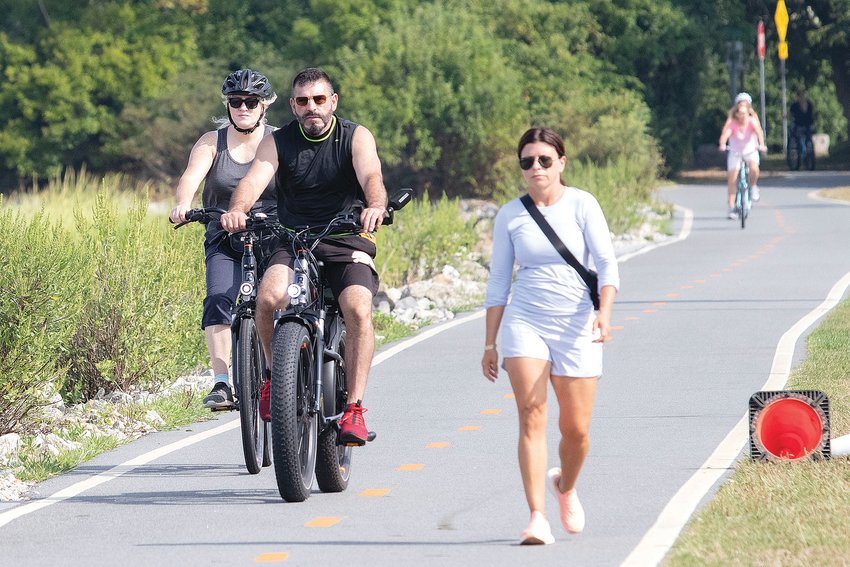 A couple of e-bikers travel south on the East Bay Bike Path, approaching Thames Street in downtown Bristol. DEM says electric bikes or other electric apparatus are not allowed on the bike path, but there is very little enforcement or understanding of the regulation.