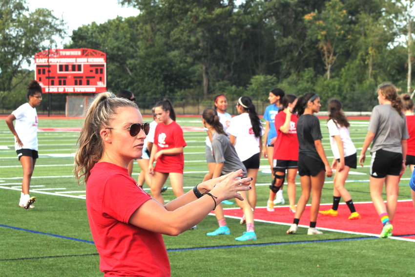 Melissa Resendes gestures while talking to her assistants as members of the 2022 East Providence High School girls' soccer team warm up before a recent practice session. Resendes, the program's all-time leading goal scorer and one of the best Townies ever, returns as the new head coach of EPHS this fall.