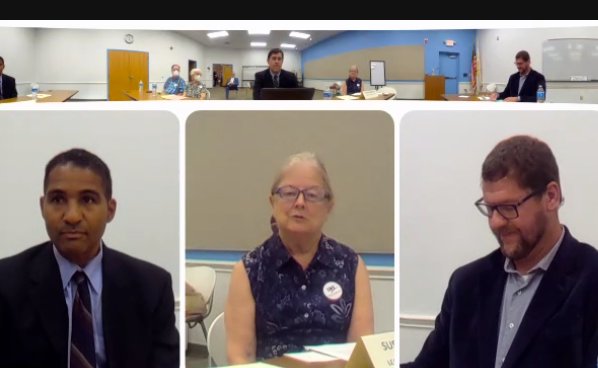 A screenshot from the 2022 Senate District 18 Democratic primary election forum held between candidates Bob Britto (far left) and Greg Greco (far right) with Susan Escherich, representing co-sponsor League of Women Voters-Rhode Island, in between.  League of Women Voters