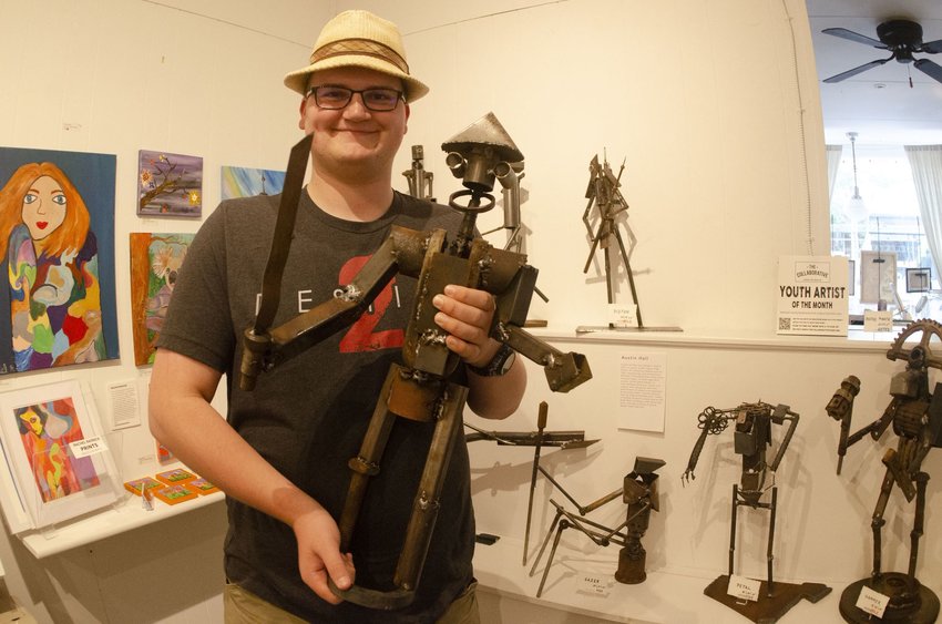 Austin Hall poses with his &ldquo;Rusty Pirate&rdquo; figurine, which he made for a sick friend as a 15-year-old amateur welder. Hall recently got to showcase his metallic creations at The Collaborative in Warren last week.