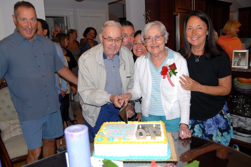 George and Adeline Correia (center) are surrounded by family and friends at a surprise 70th wedding anniversary party Saturday night in their honor.