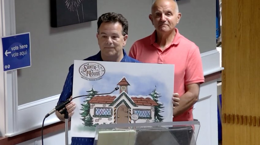 Michael Reilly (l) and Dave Scarpino of the James D. Reilly foundation, present a rendering of a Santa House they hope to site at the corner of State and Thames Streets for the holiday season.