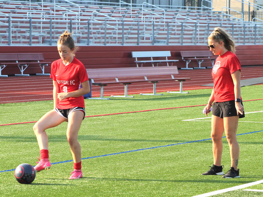 East Providence High School girls' soccer senior co-captain Jordyn Brogan (left) works her way through a possession drill under the watchful eye of new Townies' head coach Melissa Ressendes during a recent practice session. EPHS begins its 2022 Division I regular season over the next few days with a pair of games against South Kingstown and Cranston West.