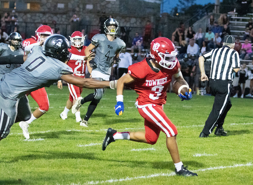 East Providence High School's Yusef Abdullah breaks away from a would-be Pilgrim tackler during the teams' non-league football game Friday night, Sept. 9, at Pierce Stadium. Abdullah scored three of the Townie touchdowns in their 47-0 win.