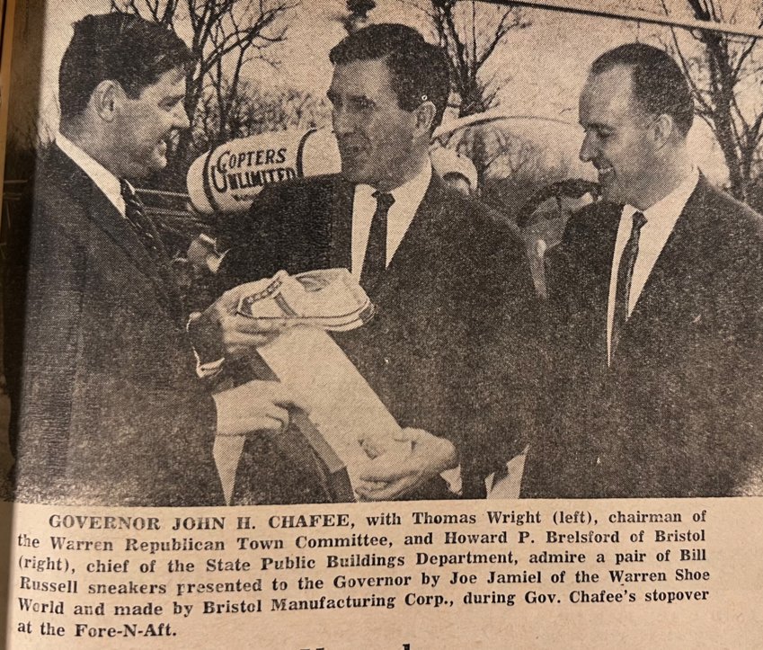 This photo, from the March 25, 1966 edition of the Phoenix, shows Governor John Chafee with Thomas Wright (left), chairman of the Warren Republican Town Committee, and Howard P. Brelsford of Bristol (right), chief of the State Public Buildings Department, admiring a pair of Bill Russell sneakers presented by Joe Jamiel of the Warren Shoe World and made by Bristol Manufacturing Corp.