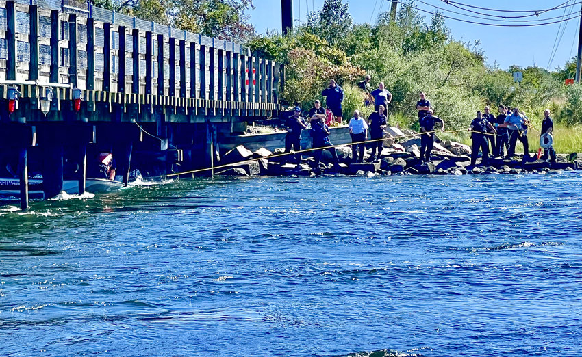 Barrington firefighters rescue a woman after her kayak capsized under the bike path bridge on Thursday morning.