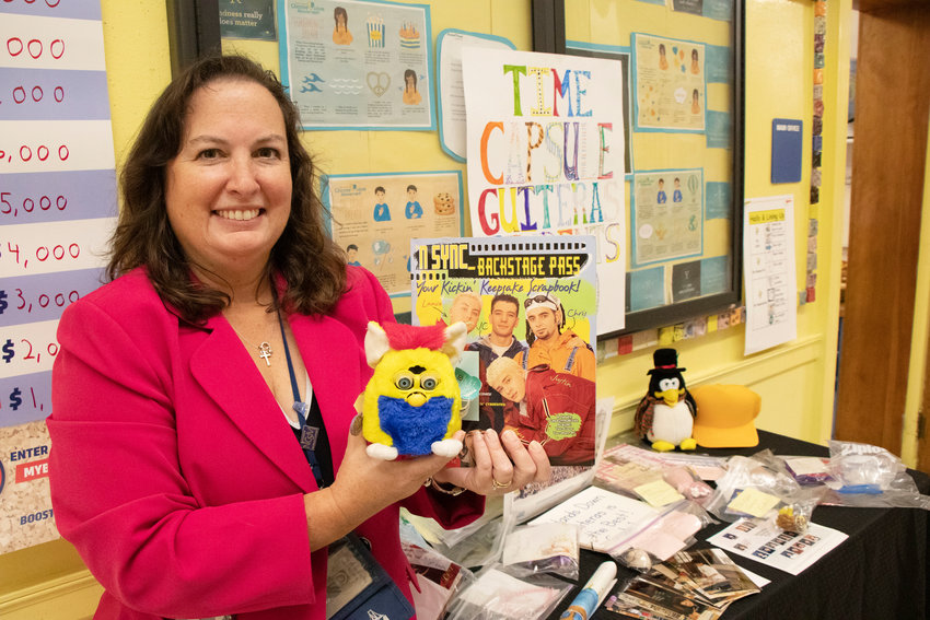 Guiteras Principal Christine Hughes with a Furby and an N&rsquo;Sync Kickin Keepsake Scrapbook &mdash; two of the many treasures uncovered when Guiteras recently opened their time capsule after 22 years.