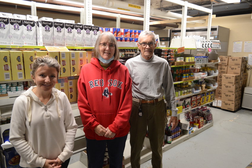 Emily Mushen, Linda Beall, and Bob Molloy, who have been volunteering for the East Bay Food Bank and Thrift Shop for two and a half years, one year, and 12 years respectively, during a normal day helping out inside the pantry. The food bank has around 160 volunteers, about half of which volunteer multiple days a week throughout the year.