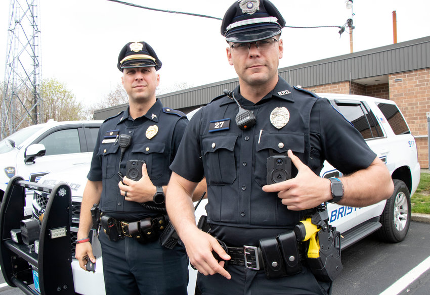 Sgt. Brian Morse (left) and patrolman Sean Gonsalves demonstrate the use of Axon body cameras, which will now be utilized by all Bristol police officers thanks to a state and federal grant.