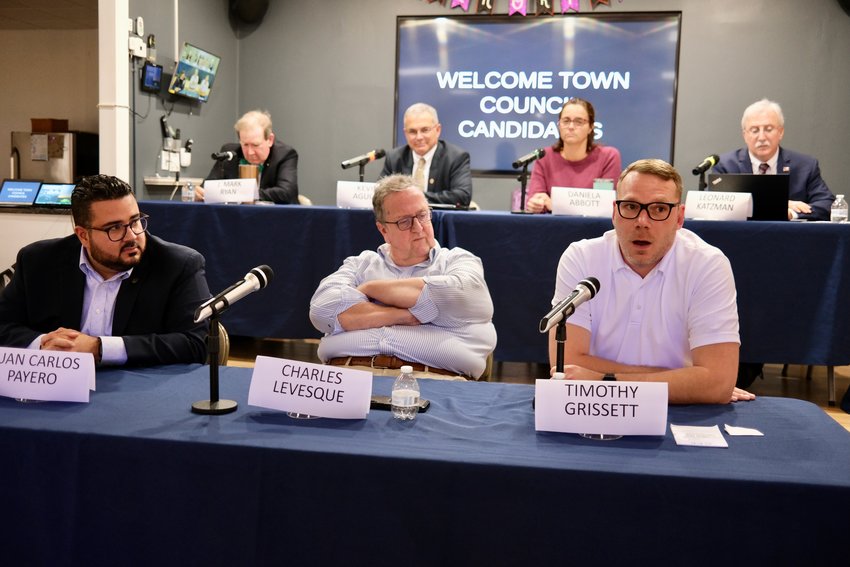 Town Council candidate Timothy Grissett (in front at right) answers a question during Thursday night&rsquo;s Portsmouth Town Council candidates&rsquo; forum hosted by the League of Women Voters of Newport County at the CFP Arts, Wellness, and Community Center. The other candidates here, all Democrats, are (front, from left) Juan Carlos Payero and Charles Levesque; and (back, from left) J. Mark Ryan, Kevin Aguiar, Daniela Abbott, and Leonard Katzman. The four Republican candidates and the one independent did not attend the forum.