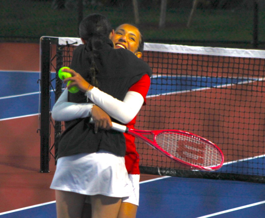 East Providence's Tiana Brierly receives a hug from teammate Caroline Haggerty after Brierly and partner Emma Gillheeney earned the deciding point in a 4-3 win over Cranston East in the D-III girls' tennis playoff quarterfinals October 28.