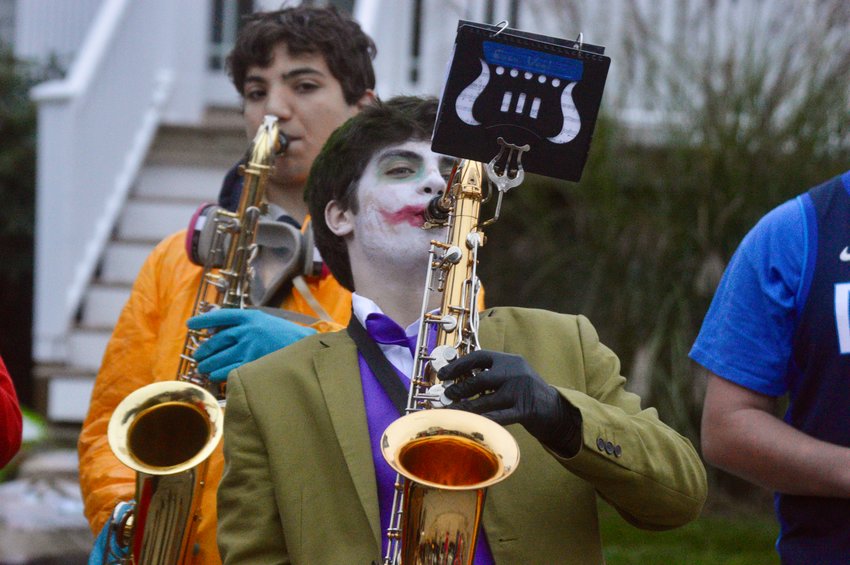 PHS senior Evan Vogl, dressed as The Joker, wails away on the sax during the band&rsquo;s Elvis tribute before the Halloween parade in Common Fence Point on Monday.