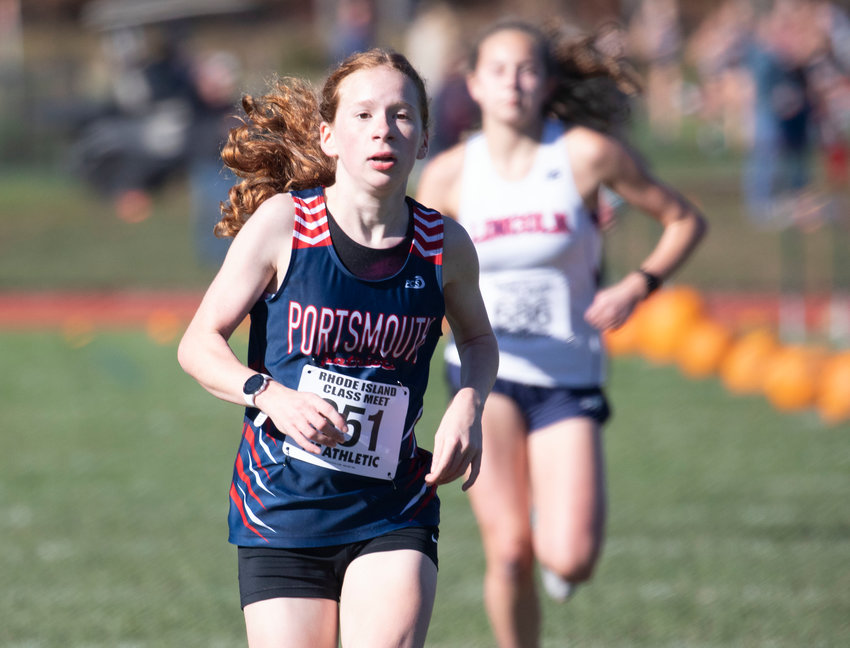 Eleni Drosinos of PHS runs through the football field towards the finish line at Saturday&rsquo;s Rhode Island Class B Championships at Ponaganset High School. She placed 12th among the girls, the best showing for the Patriots.