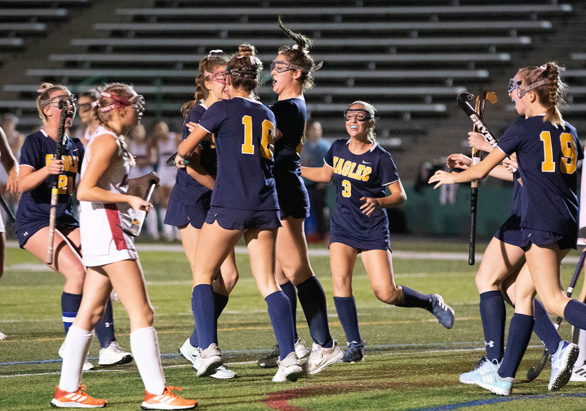 The Eagles celebrate after scoring a goal in the first quarter to take a 1-0 lead.