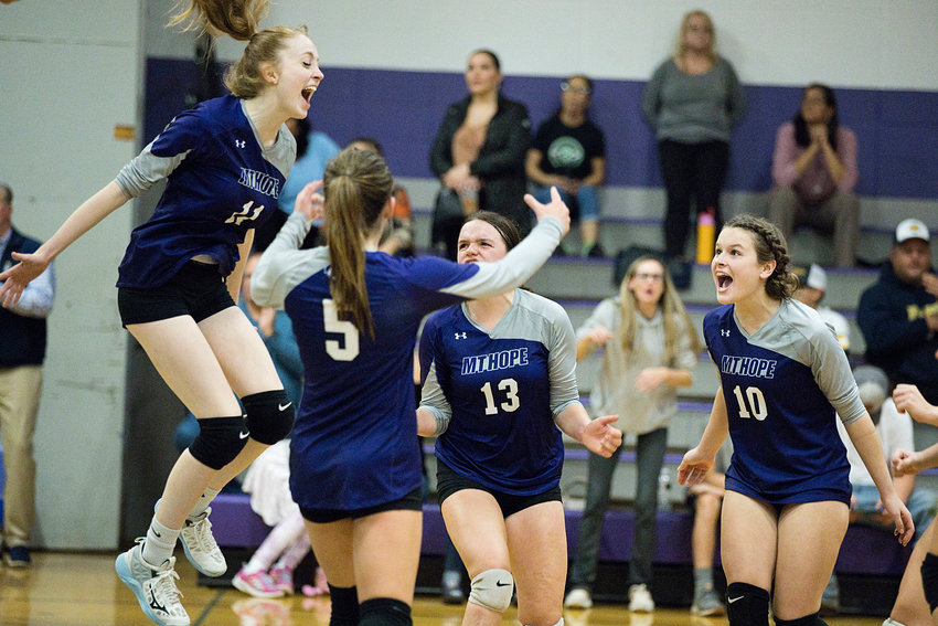 Jillian Brown (left) and her teammates celebrate after coming from behind and beating Lincoln in a home playoff game on Tuesday. The Huskies move on to face East Providence on Friday.
