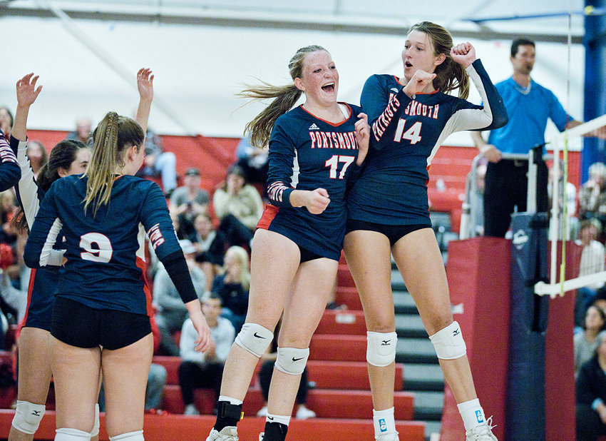 Portsmouth High&rsquo;s Avery Pelletier (left) and Morgan Casey celebrate after earning a point in the third set against East Greenwich during the Division 1 quarterfinals at home Wednesday, Nov. 2. The Patriots won in four sets.