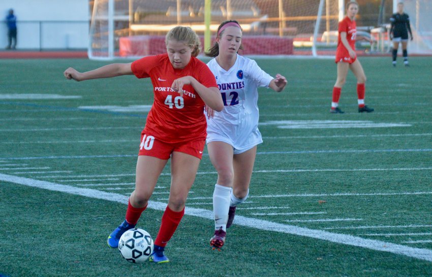 Portsmouth High&rsquo;s Mollyanna McGuire races the ball past Camille Jarret of Mt. Saint Charles during the Patriots&rsquo; quarterfinal win Thursday night at home. McGuire scored the only goal of the game, propelling the Patriots to the semifinals next week.