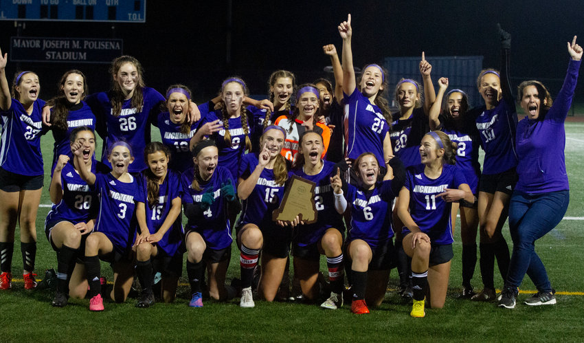 The team poses for the crowd with their championship plaque after defeating Gallagher 2-0 in the middle school state championship.