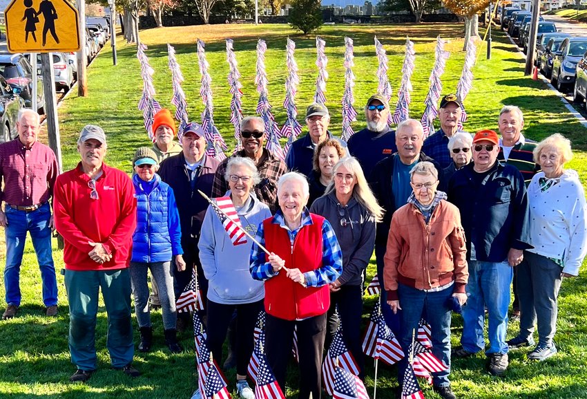 Caroline Wordell (foreground, center) is flanked by helpers. Together, they planted 900 United States flags Sunday at Pike's Peak.