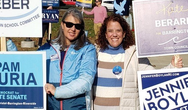 Jennifer Boylan (left) and Pam Lauria hold signs outside a polling location on Election Day. Boylan and Lauria both won their general assembly races.