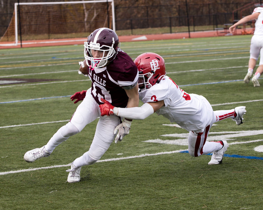 East Providence's Yusef Abdullah tackles a LaSalle runner during the 2021 Thanksgiving Day meeting of the teams.