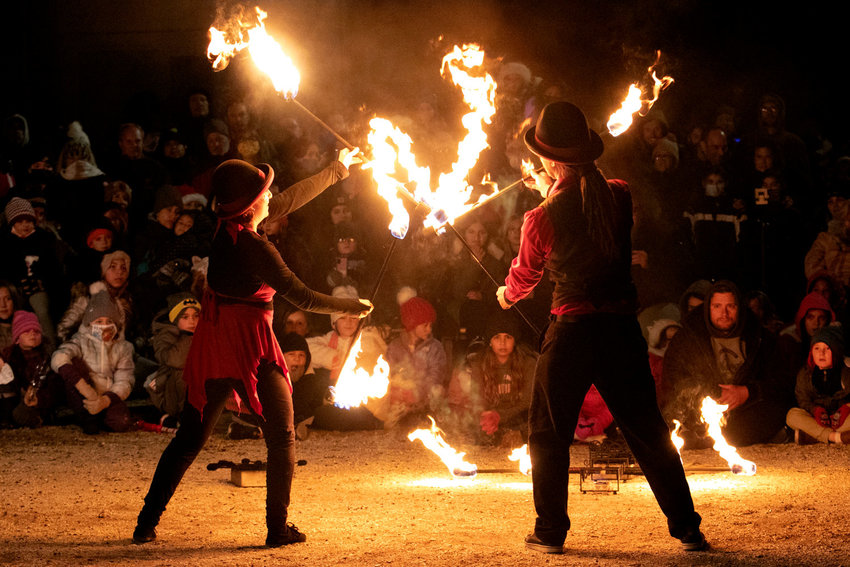Fire spinners from last year&rsquo;s Holiday Festival dazzle a crowd. Festival-goers can expect more of their impressive displays on Friday during two shows occurring at 5:15 and 6:15 at 39 Baker St.