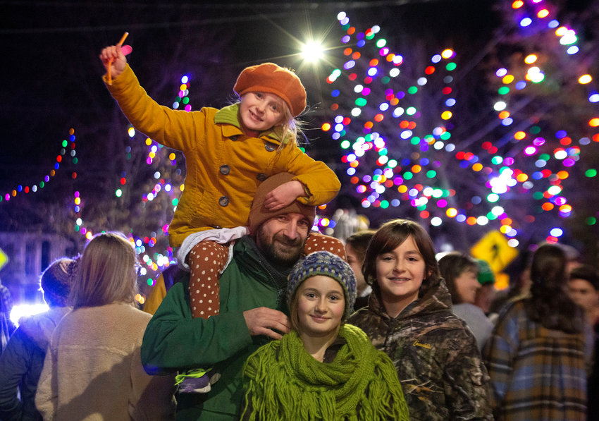 Nick Marcoux, Lynora, 7, (top), Djuna, 11, (middle) and Ari Machado, 13, (right) celebrate with the lights on Main Street.&nbsp;