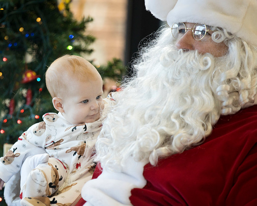 Kaylee McGuiness examines Santa's beard closely during Central Fire Company's &quot;Breakfast with Santa&quot; event, Sunday.&nbsp;