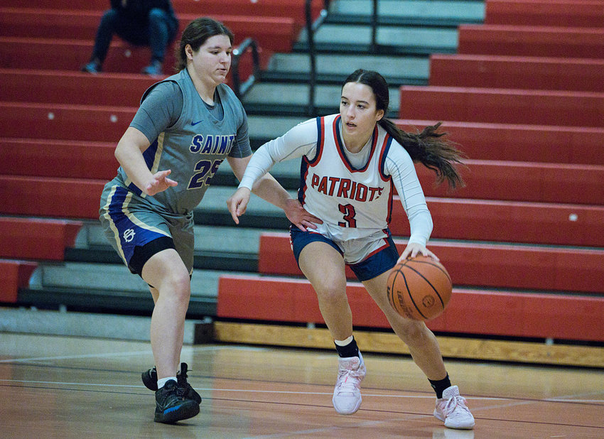 The Patriots&rsquo; Olivia Durant drives the ball past a St. Ray&rsquo;s opponent during the first half of Tuesday&rsquo;s home game. Portsmouth won, 50-34.
