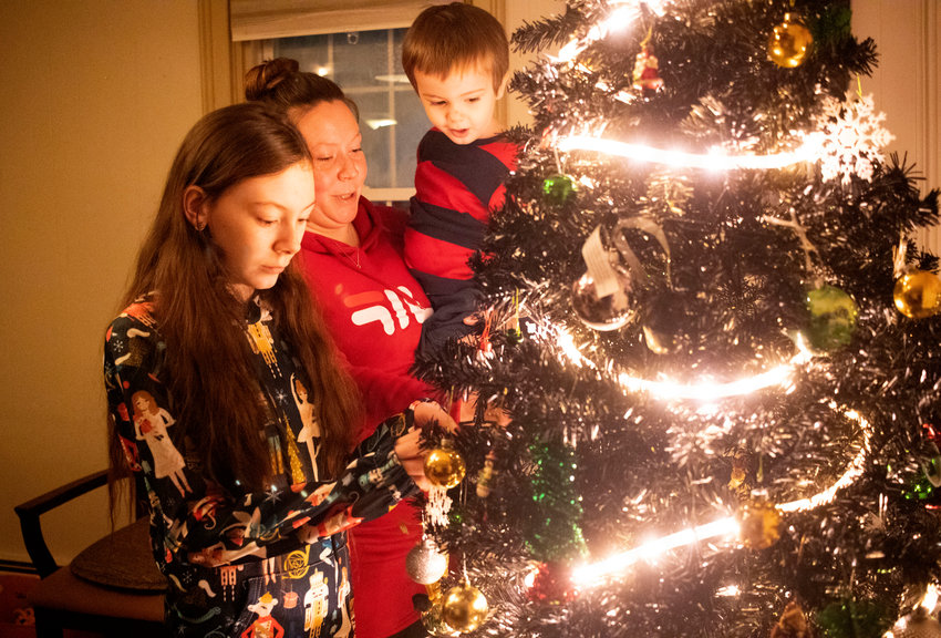 Reanne Elliott, with daughter Jamiee and son Ayden, decorate a tree in their Hope Street apartment.