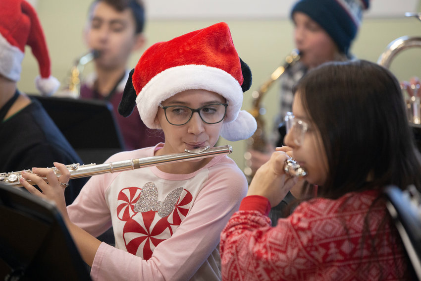 Sixth grade flutist Ruby Jewell plays &ldquo;Merry Kisimusi&rdquo; with the band.
