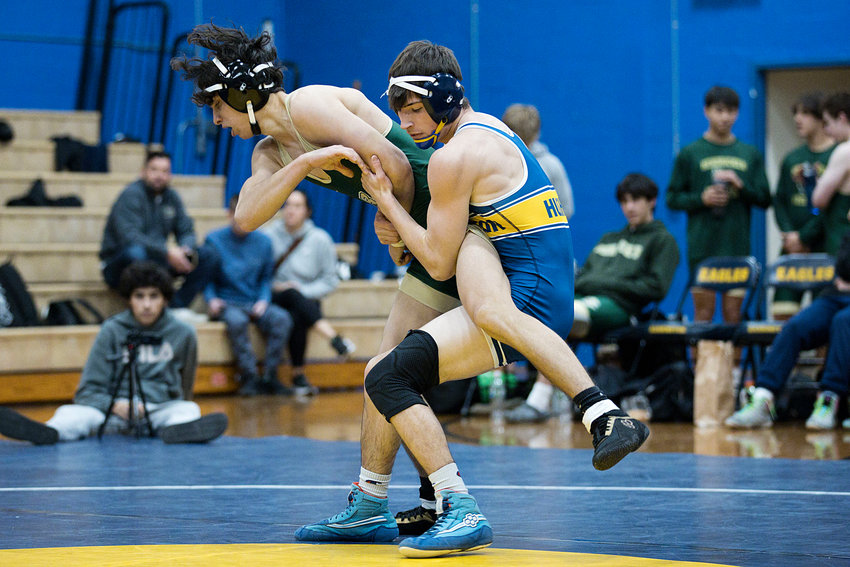 Parker Hughes competes against a Bishop Hendricken opponent in the 138 weight class during Wednesday's Varsity Tri Meet.
