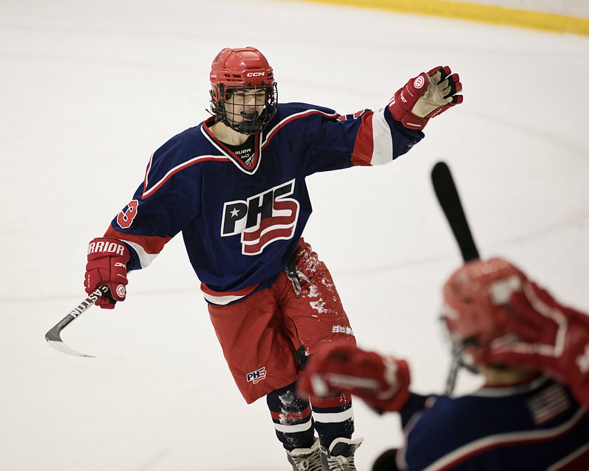 Portsmouth High&rsquo;s Benjamin West skates toward his teammates on the bench to celebrate a goal against Mt. Hope at the Portsmouth Abbey rink on Wednesday, Jan. 4., The Patriots won, 10-3.