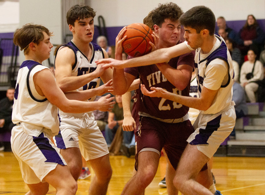 Huskies defenders Matt MacDougall, Ben Calouro and James Rustici (from left) fight for a rebound with Tiverton&rsquo;s Ryan Poland in a physical Division II matchup at Mt. Hope High School on Thursday night. Tiverton won the game, 56-42.