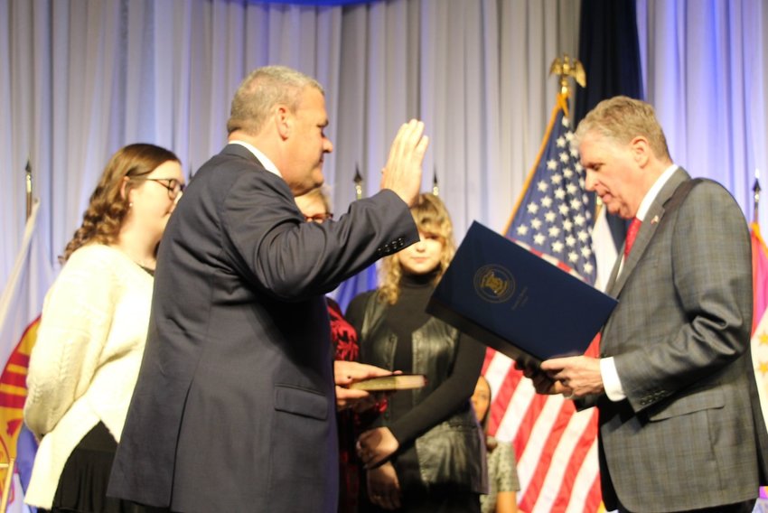 Gregg Amore takes his oath office as the new Secretary of State from Gov. Dan McKee surrounded by daughter Tess, wife Lee and daughter Meg at the Rhode Island Convention Center on January 3, 2023.