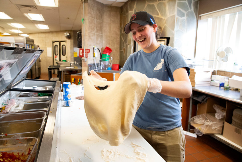 Danielle Chretien makes pizzas in the kitchen area at Clements&rsquo; Marketplace on Tuesday. &ldquo;Growing our team is a top priority in 2023,&rdquo; said Matt Ponte, spokesperson for the store.