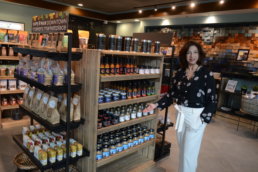 Hope &amp; Main founder Lisa Raiola showcases some of the more than 100 products that are available for sale at the marketplace, which all came from businesses that began at Hope &amp; Main in Warren.