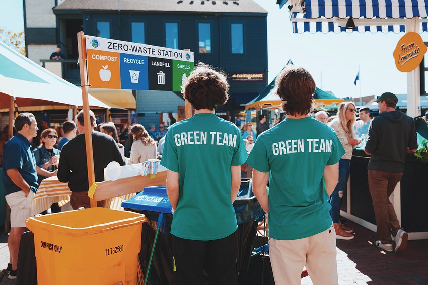 A couple of &ldquo;Green Team&rdquo; volunteers monitor a &ldquo;Zero-Waste Station&rdquo; at a Newport festival last summer. The event planner and volunteers worked together to separate the thousands of pounds of waste into &mdash; literally &mdash; separate buckets, so it could go into separate waste streams. Over the course of 15 such events, Clean Ocean Access was able to divert more than 26,000 pounds of waste from Rhode Island&rsquo;s central landfill.