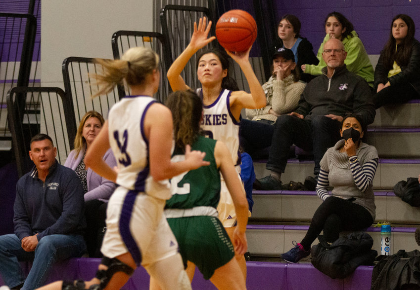 Elsa White shoots a 3-pointer as fans look on during Mt. hope's loss to Chariho on Thursday night. The Huskies rebounded to wallop Woonsocket on Friday.