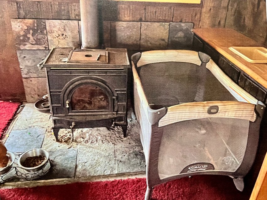 A child&rsquo;s pack &rsquo;n play sits directly beside a wood-burning stove inside the house at 36 Kinnicutt Ave. An inspection of the house&rsquo;s interior last week led to its condemnation on Monday morning.