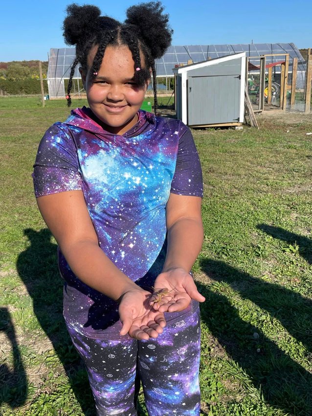 Amani Helger, a fifth-grader at Portsmouth Middle School, shows off a critter she found at the Portsmouth AgInnovation Farm, which was just awarded $78,889 in grant funding from the van Beuren Charitable Foundation.