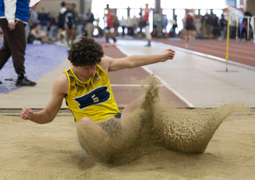 Barrington's Eli Terrell lands a long jump during a recent indoor track meet.