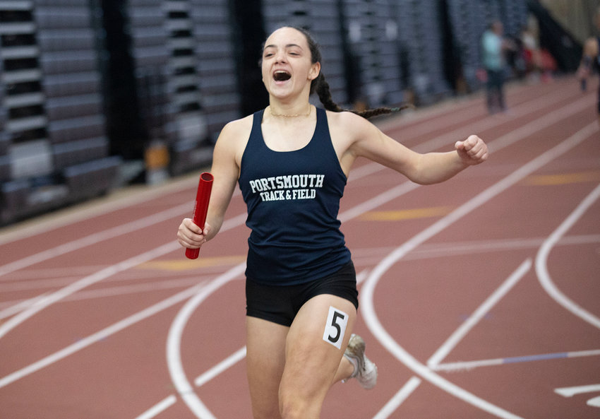 Portsmouth High&rsquo;s Elly Skeels smiles as she finishes the 4x200-meter girls&rsquo; relay finals ahead of her rivals during Saturday&rsquo;s Indoor Track and Field Class Championships at the Providence Career &amp; Technical Academy. The PHS team, which also featured Poppy Jelley, Sonia Staroscik, and Emily Deconto, clocked a time of 1:51.27 to win the event in the Medium Division.