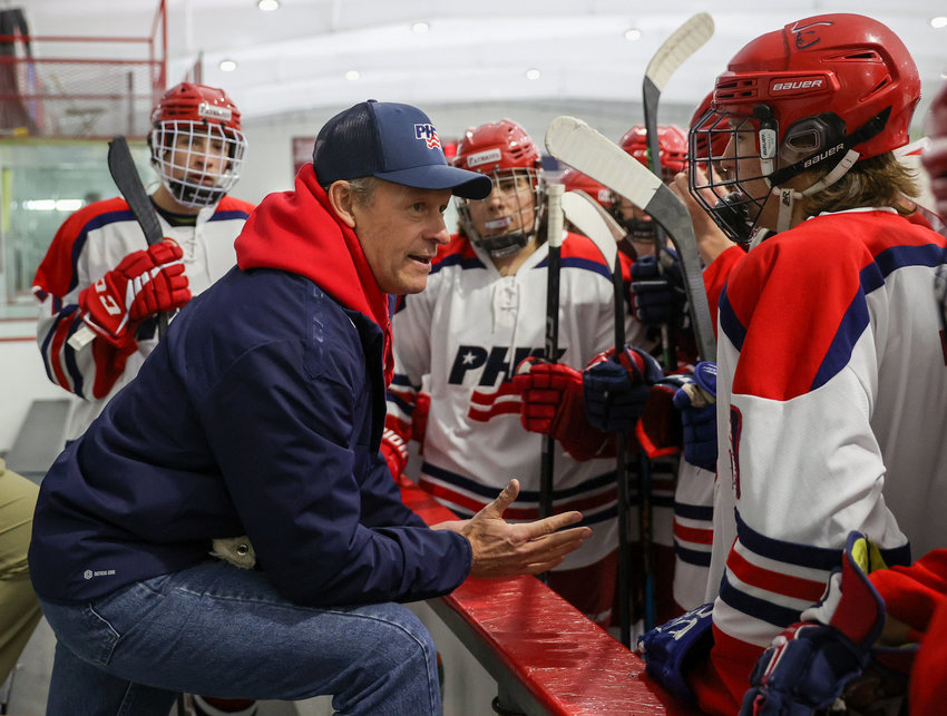Portsmouth High boys&rsquo; hockey team head coach Greg Cunningham talks with his players during an Injury Fund game against Barrington in December.
