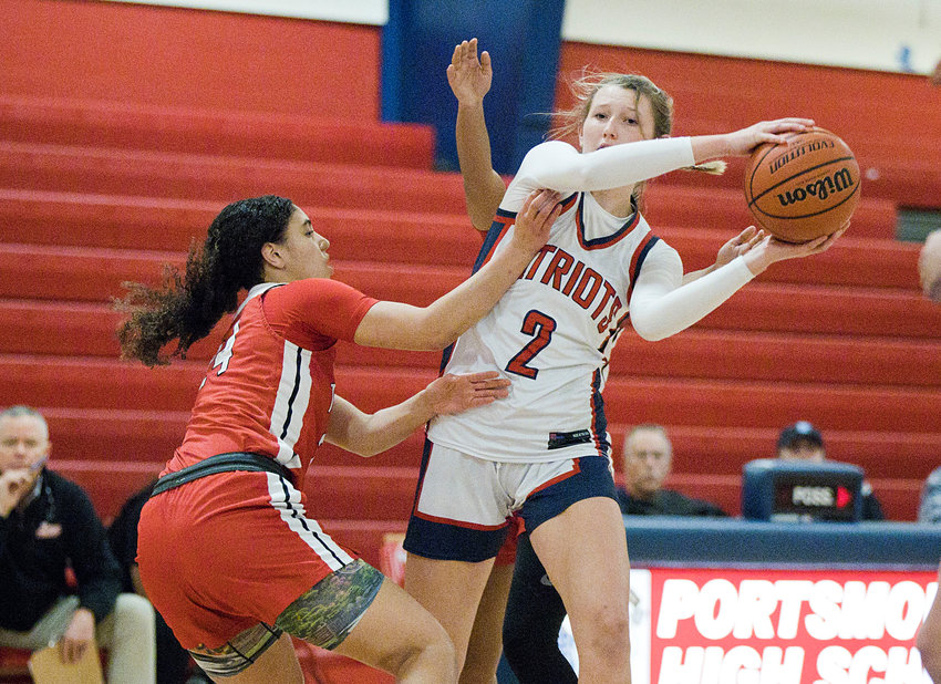 Portsmouth High&rsquo;s Morgan Casey looks to pass while being sandwiched by a pair of East Providence opponents during the Patriots&rsquo; 59-46 home win Thursday night, Feb. 9.
