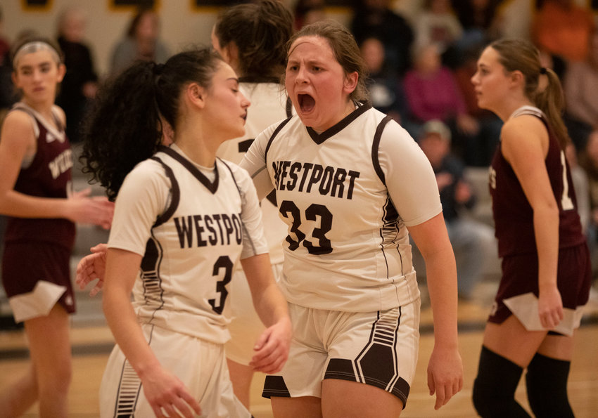 Sarah Perry cheers on her teammate Korynne Holden after she drove in and made a basket during the Wildcats loss to West Bridgewater on Wednesday. Westport bounced back and demolished Holbrook 59-26 on Friday.