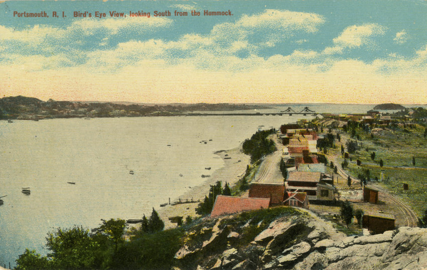 This postcard from 1914 was taken atop the high, rocky bluffs at the Hummocks, looking south. You can see the old Stone Bridge and Gould Island in the background.