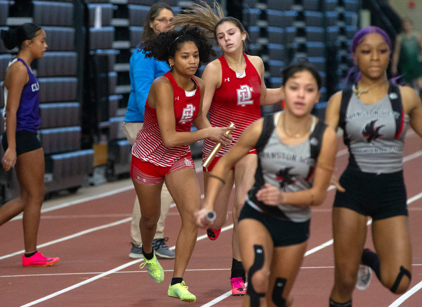 EPHS's Samantha Clarke passes the baton to mate Giselle Raphael during a recent 4x200 meter relay. The duo along with Kandace Daniel and Nazarae Phillip broke the school record in the event at last week's Class A meet.